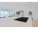 Kitchen island with double basin sink, modern faucet, and white quartz countertop at 1365 E Avenida Ellena Ln, Casa Grande, AZ 85122