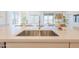 Double basin stainless steel kitchen sink with a modern faucet and white countertop at 1365 E Avenida Ellena Ln, Casa Grande, AZ 85122