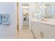 Main bathroom with dual sink vanity, walk-in closet, and tiled floor at 1365 E Avenida Ellena Ln, Casa Grande, AZ 85122