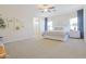 Spacious main bedroom with plush carpet, ceiling fan, and ensuite bathroom at 1365 E Avenida Ellena Ln, Casa Grande, AZ 85122