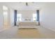 Main bedroom with ceiling fan, carpeted floors, and large bed at 1365 E Avenida Ellena Ln, Casa Grande, AZ 85122