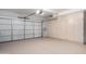 Spacious garage interior with storage cabinets and white garage door at 14039 N 13Th St, Phoenix, AZ 85022