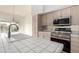 Kitchen featuring stainless steel appliances, light wood cabinets, and tile countertops and backsplash at 14039 N 13Th St, Phoenix, AZ 85022