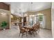 Bright dining room with a large wooden table and view to game room at 1449 W Iris Dr, Gilbert, AZ 85233