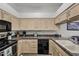 Kitchen featuring oak cabinets, black appliances, and granite countertops at 16357 E Arrow Dr # 116, Fountain Hills, AZ 85268