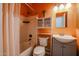 Clean bathroom with shower/tub combination, vanity sink, and storage cabinet at 1714 E Behrend Dr, Phoenix, AZ 85024