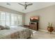 Bedroom with a queen bed, large TV, and wood flooring at 1741 E Adelante Way, Queen Creek, AZ 85140