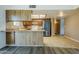 Kitchen and dining area with a breakfast bar and wood cabinetry at 1906 N Evergreen St, Chandler, AZ 85225