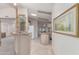 Hallway view of a wet bar with a glass cabinet, leading to the kitchen at 2233 E Behrend Dr # 146, Phoenix, AZ 85024