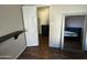 Bedroom with wood laminate floors, closet, and full-length mirror at 2605 E 10Th St, Tempe, AZ 85288