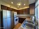 Compact kitchen with stainless steel appliances and white cabinets at 2605 E 10Th St, Tempe, AZ 85288