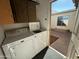 Laundry room with white washer and dryer and overhead cabinets at 2605 E 10Th St, Tempe, AZ 85288