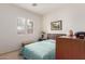 Bright bedroom with teal bedding, carpet, and a window with shutters at 33010 N 23Rd Ave, Phoenix, AZ 85085