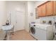 Laundry room with washer, dryer, and cabinets at 33010 N 23Rd Ave, Phoenix, AZ 85085