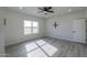 Bedroom featuring wood-look tile flooring, large window with natural light, and ceiling fan at 43521 W Carefree Pl, Maricopa, AZ 85138