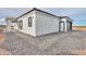 White single-story home with black trim, covered patio, and attached garage at 43521 W Carefree Pl, Maricopa, AZ 85138