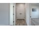 Hallway with wood-look tile flooring and white double doors at 43521 W Carefree Pl, Maricopa, AZ 85138