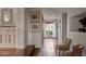 Hallway with hardwood floors, antique chairs, and a view of the backyard at 5057 E Sky Desert Ln, Paradise Valley, AZ 85253