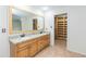 Main bathroom with double sinks, granite countertop, and walk-in closet at 5334 N 20Th St, Phoenix, AZ 85016