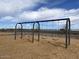 Set of swings at a playground under a blue sky at 5606 W Olney Ave, Laveen, AZ 85339