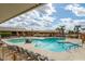 Large community pool with lounge chairs, hot tub, and shade structure at 625 S Desert Flower Dr, Mesa, AZ 85208