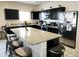 Modern kitchen featuring dark cabinets, stainless steel appliances, and a large island at 8506 S 256Th Dr, Buckeye, AZ 85326