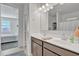 Double vanity bathroom with modern fixtures and a view into bedroom at 1057 W Chimes Tower Dr, Casa Grande, AZ 85122