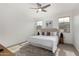 Bright bedroom with a king-size bed, ceiling fan, and carpeted floors at 11003 E Tesla Ave, Mesa, AZ 85212