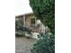 Side view of the home with porch, landscaping, and green shrubs at 11596 W Sierra Dawn Blvd # 156, Surprise, AZ 85378