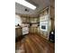 Kitchen with wood cabinets, white appliances, and a window overlooking the outdoors at 11596 W Sierra Dawn Blvd # 156, Surprise, AZ 85378