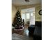 Inviting living area with a Christmas tree, sectional sofa, and front door entrance at 11596 W Sierra Dawn Blvd # 156, Surprise, AZ 85378