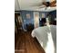Cozy main bedroom with wood-look flooring, ceiling fan, and ample natural light at 11596 W Sierra Dawn Blvd # 156, Surprise, AZ 85378