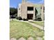 Exterior view of a two-story condo with stairs, balcony, and green lawn at 1295 N Ash St # 114, Gilbert, AZ 85233