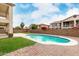 Backyard with a pool, grassy area, and brick pavers at 15835 W Desert Mirage Dr, Surprise, AZ 85379
