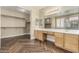 Large bathroom with double vanities, a walk-in closet, and tiled floors at 15835 W Desert Mirage Dr, Surprise, AZ 85379