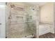 Modern bathroom with tiled walk-in shower, soaking tub, and updated fixtures at 15835 W Desert Mirage Dr, Surprise, AZ 85379