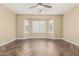 Expansive bedroom with a bay window, wood-look tile flooring, and neutral walls at 15835 W Desert Mirage Dr, Surprise, AZ 85379