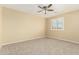 Unfurnished bedroom featuring carpeted flooring and window with shutters at 15835 W Desert Mirage Dr, Surprise, AZ 85379