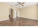 Spacious bedroom with wood-look tile floors and a ceiling fan at 15835 W Desert Mirage Dr, Surprise, AZ 85379