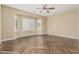 Bright bedroom featuring bay windows, wood-look tile floors, and neutral walls at 15835 W Desert Mirage Dr, Surprise, AZ 85379