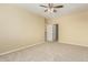 Empty bedroom with ceiling fan and carpeted floors at 15835 W Desert Mirage Dr, Surprise, AZ 85379
