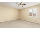 Cozy bedroom with carpeted flooring, window with shutters, and neutral paint at 15835 W Desert Mirage Dr, Surprise, AZ 85379
