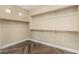 Spacious walk-in closet with built-in shelves, hanging rods, and tile floors at 15835 W Desert Mirage Dr, Surprise, AZ 85379