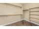 Large walk-in closet featuring hanging rods, shelving, and ample storage space at 15835 W Desert Mirage Dr, Surprise, AZ 85379