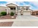 Two-story home with a three-car garage and desert landscaping at 15835 W Desert Mirage Dr, Surprise, AZ 85379