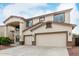 Two-story home with a three-car garage and covered entryway at 15835 W Desert Mirage Dr, Surprise, AZ 85379