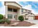Front yard with a covered entryway, landscaping, and a three-car garage at 15835 W Desert Mirage Dr, Surprise, AZ 85379