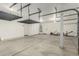 Spacious garage with overhead storage and white walls at 15835 W Desert Mirage Dr, Surprise, AZ 85379