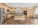 Kitchen features wood cabinetry, granite countertops, and stainless steel appliances at 15835 W Desert Mirage Dr, Surprise, AZ 85379