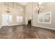 Spacious living room with high ceilings, wood-look tile floors, and a fireplace at 15835 W Desert Mirage Dr, Surprise, AZ 85379